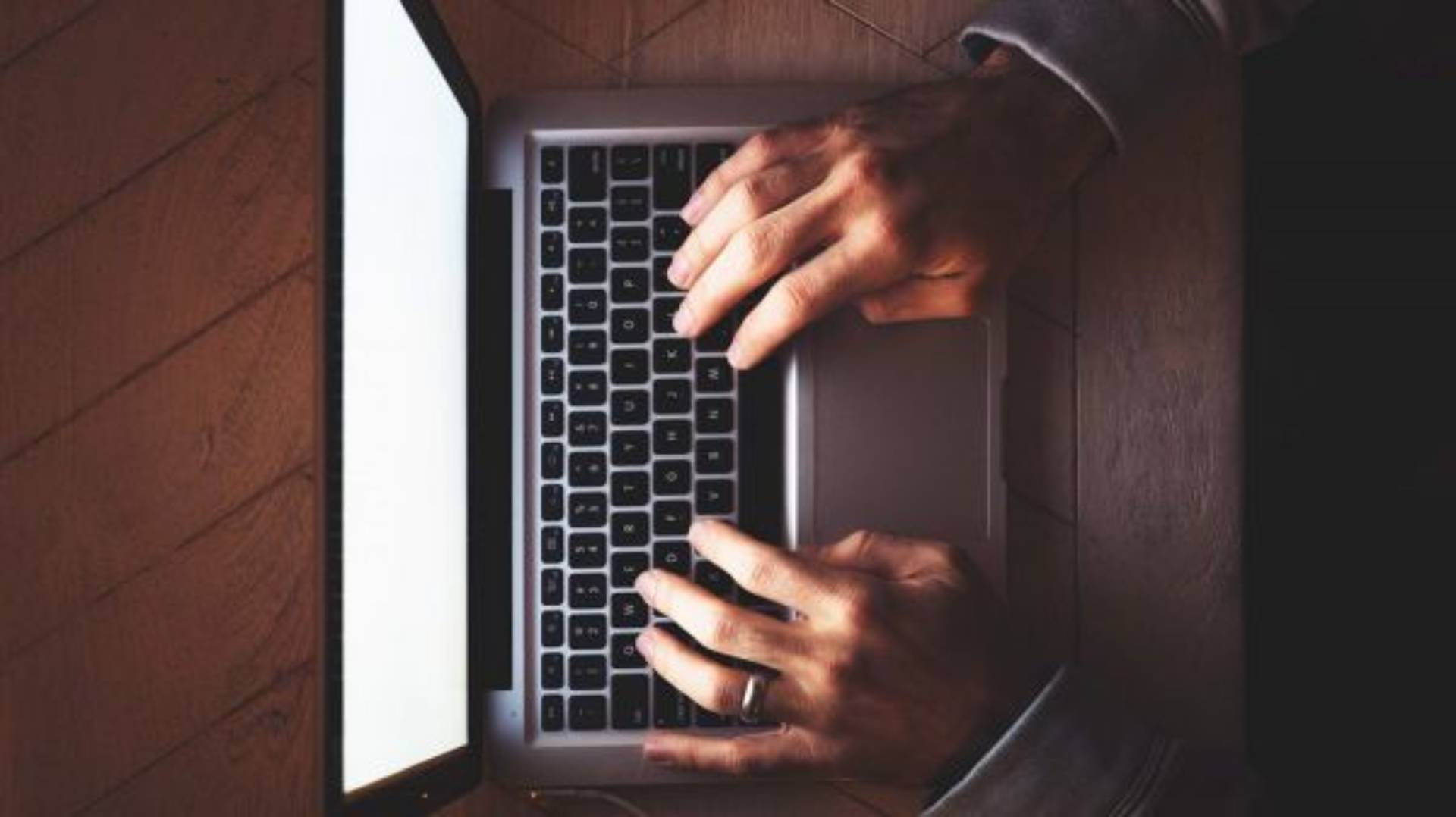 top down view of hands on a laptop keyboard