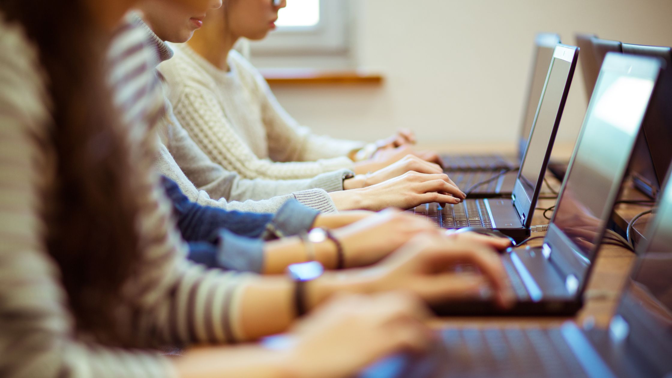 students at computers representing the idea of possible cyber attack exposure at a school.